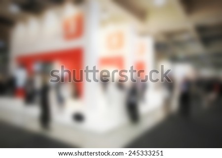 People visit a trade show, humans not recognizable. Intentional blurred post production.