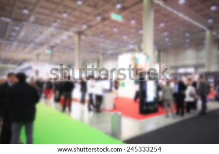 People visit a trade show, humans not recognizable. Intentional blurred post production.