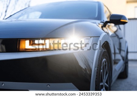 The modern headlights or front light of the automobile car in the capital city. Car led light signal dim and full loop. Emergency flashing car light lamp, warning sign. Nobody around to help