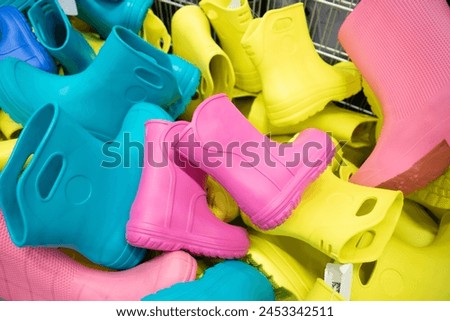  Childlike multi-colored rubber boots in the store Royalty-Free Stock Photo #2453342511