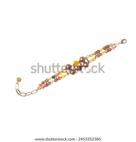 Amber bracelet with semiprecious stones isolated on white background Royalty-Free Stock Photo #2453352385