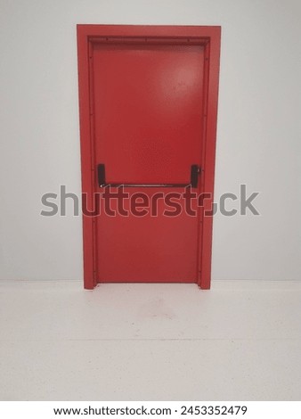 A closed red fire exit door