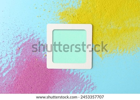 Empty  frame in yellow, blue, and purple textured background sprinkled with colorful sand. Ideal for creative designs