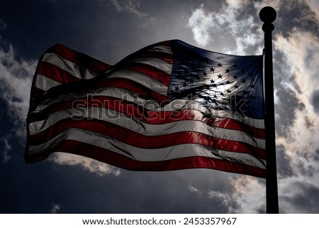 Waving american flag on dark dramatic sky. USA flag. Grunge American flag. US flag and sunrise. Independence day.