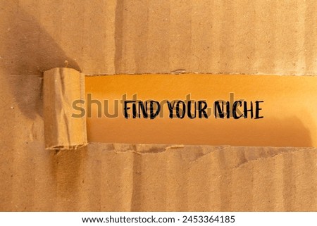 Find your niche words written on ripped cardboard paper with orange background. Conceptual find your niche symbol. Copy space.