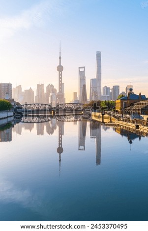 view of shanghai skyline at dawn, river and bridge