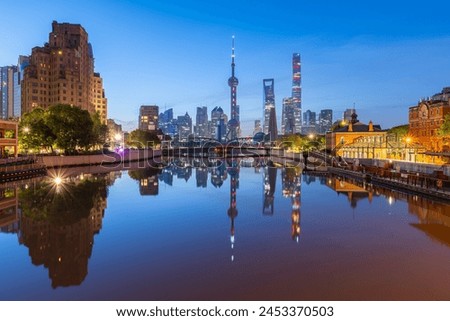 view of shanghai skyline at dawn, river and bridge