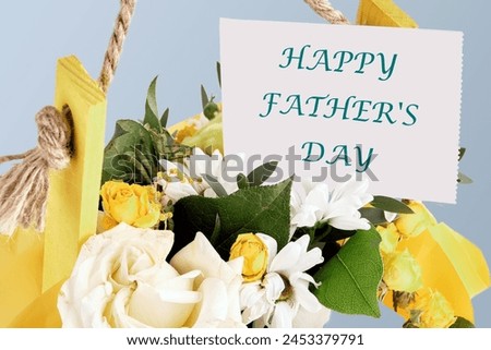 HAPPY FATHER'S DAY text on a business card in a bouquet of flowers