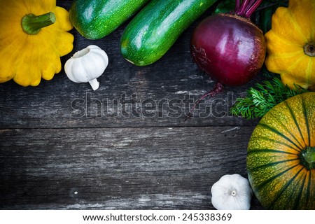 Fresh organic seasonal vegetables - pumpkin, squash, beetroot on wooden background