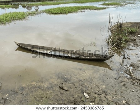Rural areas in South Kalimantan. April 21, 2024. Old traditional wooden boat in village rice fields. Photo taken from a height. Royalty-Free Stock Photo #2453386765