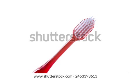 Close-up of red toothbrush head with thin neck isolated on white background, diagonal view. Royalty-Free Stock Photo #2453393613
