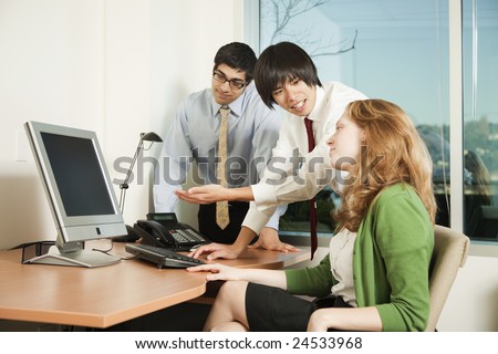 Photo of a consultant explaining the contents of an LCD computer screen.