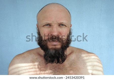Men's beard. The guy's face is large. Brutal macho. Mustache and beard. Barber. Lumberjack. Portrait of a handsome man with a beard                                Royalty-Free Stock Photo #2453420391