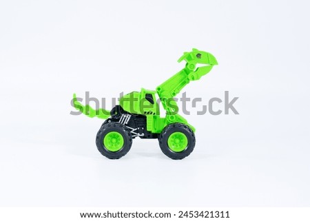 Children's toy green  on a white isolated background.Plastic child toy on white backdrop. Children's toy.