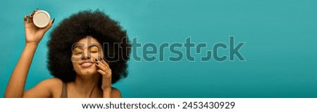 Stylish African American woman holding cream.