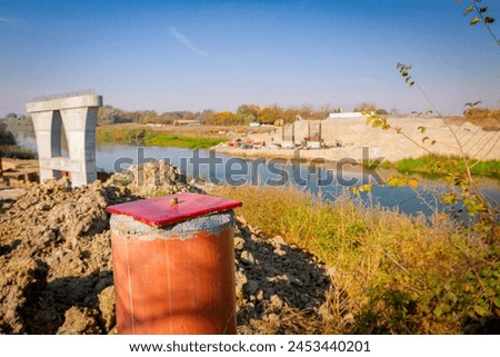 Red metal pole, side device, for determine level of bridge, 4 points for determining exact dimensions and check elevations. Construction of the bridge is in progress. Royalty-Free Stock Photo #2453440201