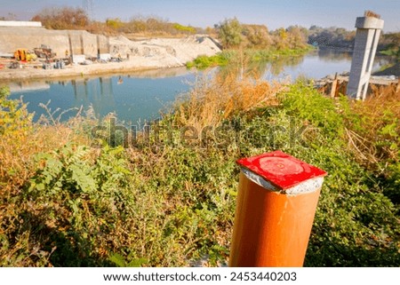 Red metal pole, side device, for determine level of bridge, 4 points for determining exact dimensions and check elevations. Construction of the bridge is in progress. Royalty-Free Stock Photo #2453440203