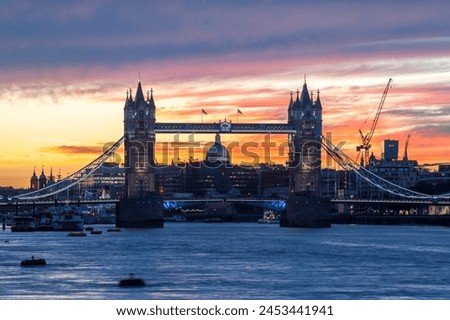 Tower Bridge, St. Paul's Cathedral and the City skyline over the River Thames at sunset, London, England, United Kingdom, Europe