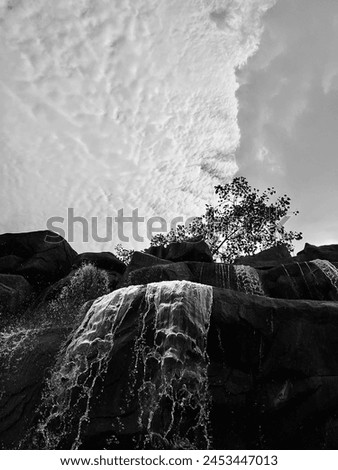 A black and white picture of a waterfall