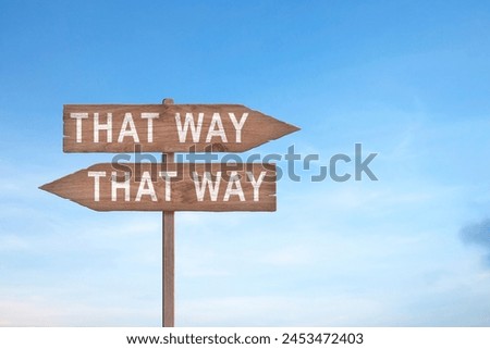 Crossroad signpost saying this way, that way, the other way concept for lost, confusion or decisions Royalty-Free Stock Photo #2453472403