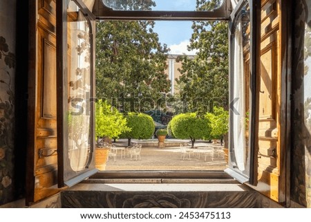 Details from the sumptuous and rich interior of the Palazzo Colonna in Rome, Italy. Looking out the window to the beautiful courtyard. Royalty-Free Stock Photo #2453475113