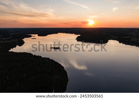 Beautiful sunset aerial view of lake Galve, one of most popular lakes among water-based tourists, divers and holiday makers, located in Trakai, Lithuania. Royalty-Free Stock Photo #2453503561