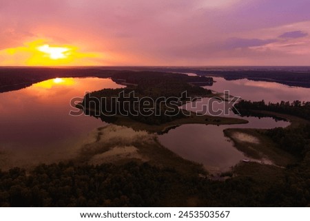 Beautiful sunset aerial view of lake Galve, one of most popular lakes among water-based tourists, divers and holiday makers, located in Trakai, Lithuania. Royalty-Free Stock Photo #2453503567
