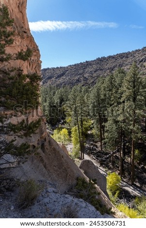 Bandelier National Monument preserves Ancestral Puebloans home in New Mexico. View of Frijoles Canyon from Alcove House. Trail to Alcove House over Frijoles creek.  Royalty-Free Stock Photo #2453506731
