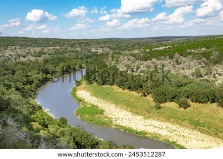 Scenic view of the Texas Hill Country trees and Colorado River from a summit at Colorado Bend State Park. Photo taken on a party cloudy day