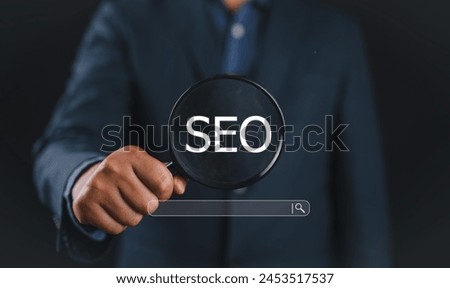 Businessman using magnifying glass focus to SEO icon to analyze SEO search engine optimization for promoting ranking traffic on website and optimizing your website to rank in search engines.