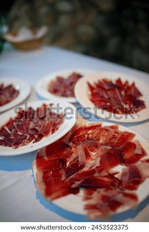 close up view of a plate of serrano ham, classic spanish Royalty-Free Stock Photo #2453523375