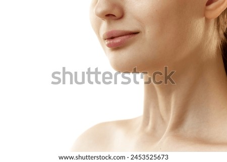 Cropped photo of young woman with well-kept, rejuvenated skin at on neckline zone against white studio background. Concept of natural beauty, organic cosmetic, spa procedures, face-care. Royalty-Free Stock Photo #2453525673