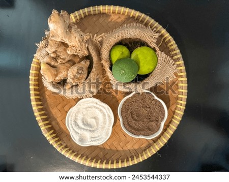 Fresh natural ingredients on a woven bamboo plate ready to be processed into herbal medicine Royalty-Free Stock Photo #2453544337