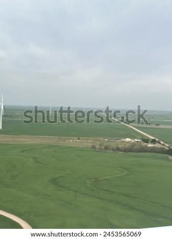Beautiful picture of the Oklahoma landscape capturing a wind turbine farm from an aerial view. Perfect for a background.