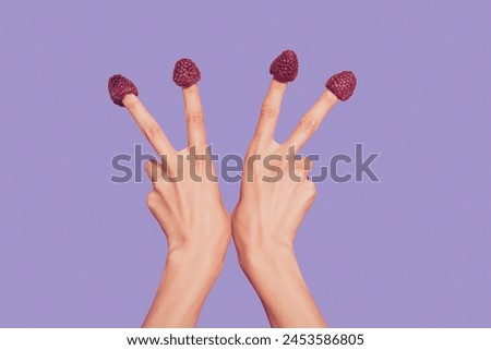 Close-up cropped delicate well-groomed two hands four fingers sweet berries hats on nails showing v-sign isolated over pink pastel background