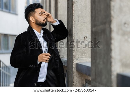 Unhappy sad Indian business man frustrated stress pensive feeling bad after company lost job unemployment problem financial crisis. Arabian Hindu freelancer guy stay at office business center building Royalty-Free Stock Photo #2453600147