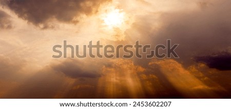 cloudy sunset sky with sun's rays