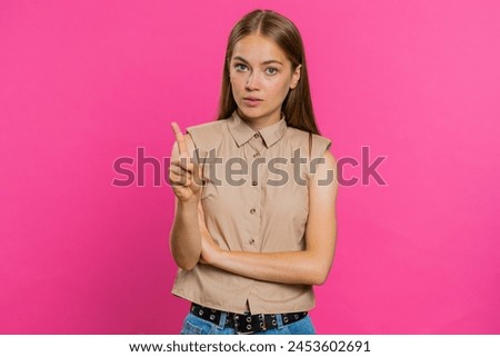 Displeased upset Caucasian woman reacting to unpleasant awful idea, dissatisfied with bad quality, wave hand, shake head No, dismiss idea, dont like proposal. Girl isolated on pink studio background Royalty-Free Stock Photo #2453602691