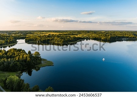 Beautiful aerial view of lake Galve, one of most popular lakes among water-based tourists, divers and holiday makers, located in Trakai, Lithuania. Royalty-Free Stock Photo #2453606537