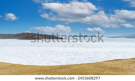 Lake Baikal. Snow-covered ice. Beautiful winter landscape. Cold weather. Nature of Siberia. High quality photo