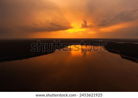 Beautiful sunset aerial view of lake Galve, one of most popular lakes among water-based tourists, divers and holiday makers, located in Trakai, Lithuania. Royalty-Free Stock Photo #2453621925