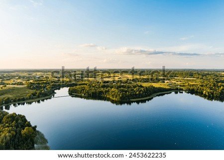 Beautiful aerial view of lake Galve, one of most popular lakes among water-based tourists, divers and holiday makers, located in Trakai, Lithuania. Royalty-Free Stock Photo #2453622235