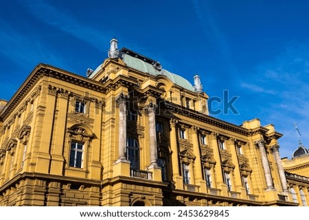 The Croatian National Theatre in Zagreb, an exemplar of neo-renaissance architecture under the bright blue sky. Royalty-Free Stock Photo #2453629845