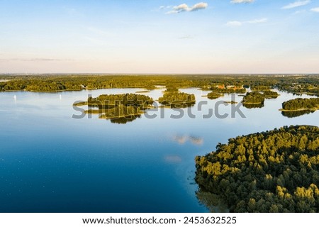 Beautiful aerial view of lake Galve, one of most popular lakes among water-based tourists, divers and holiday makers, located in Trakai, Lithuania. Royalty-Free Stock Photo #2453632525