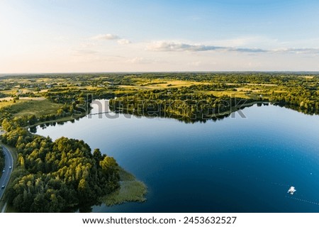 Beautiful aerial view of lake Galve, one of most popular lakes among water-based tourists, divers and holiday makers, located in Trakai, Lithuania. Royalty-Free Stock Photo #2453632527