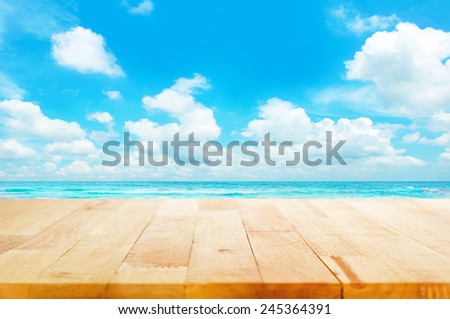 Wood table top on blue sea & sky background can put or montage your products for display - beach & summer concepts