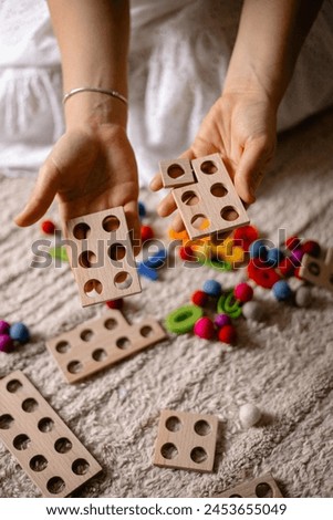 young woman holding multi-colored wooden numbers in her hands