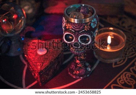 Altar cups with a skull with flowers. Santa Muertos or Saint death concept
