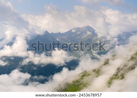 Early morning mountain views at Eisseehütte with fluttering clouds and pastel greens and blues, Hohe Tauern National Park, Osttirol, Austria Royalty-Free Stock Photo #2453678957