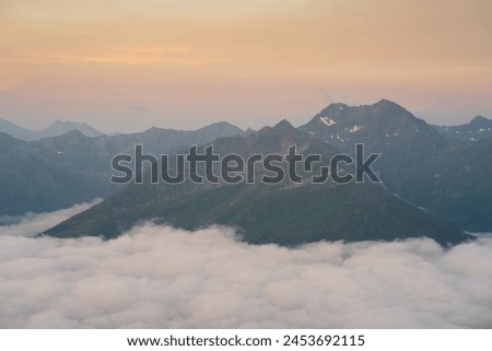 Golden summer sunrise over a cloud inversion in the Hohe Tauern National Park, Osttirol, Austria Royalty-Free Stock Photo #2453692115